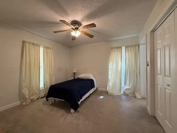 a living room with a bed and a chandelier