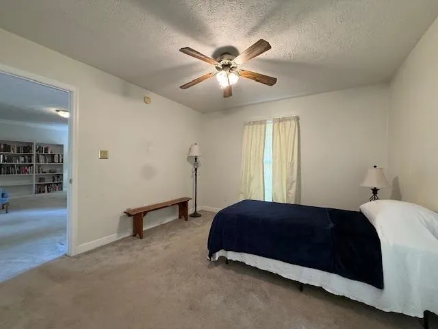 a bedroom with a bed and window