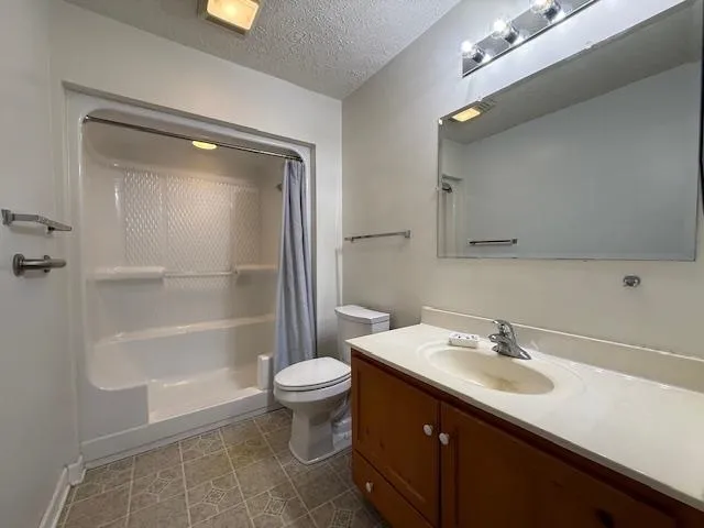 a bathroom with a sink toilet a mirror and shower