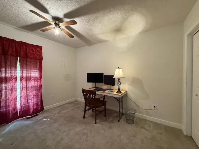 a workspace with furniture and chandelier fan