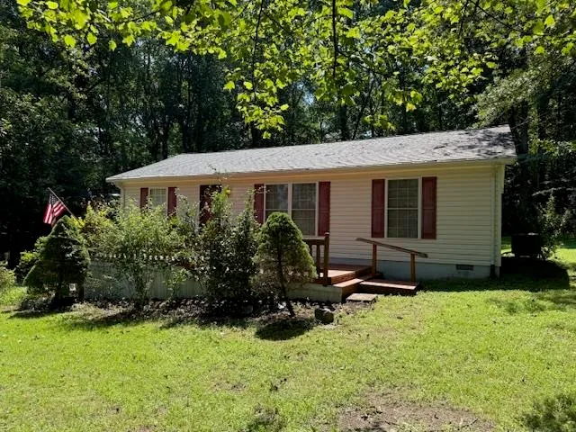 a view of a house with backyard sitting area and garden