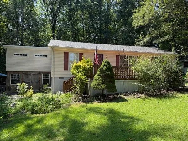 a view of house with backyard and garden