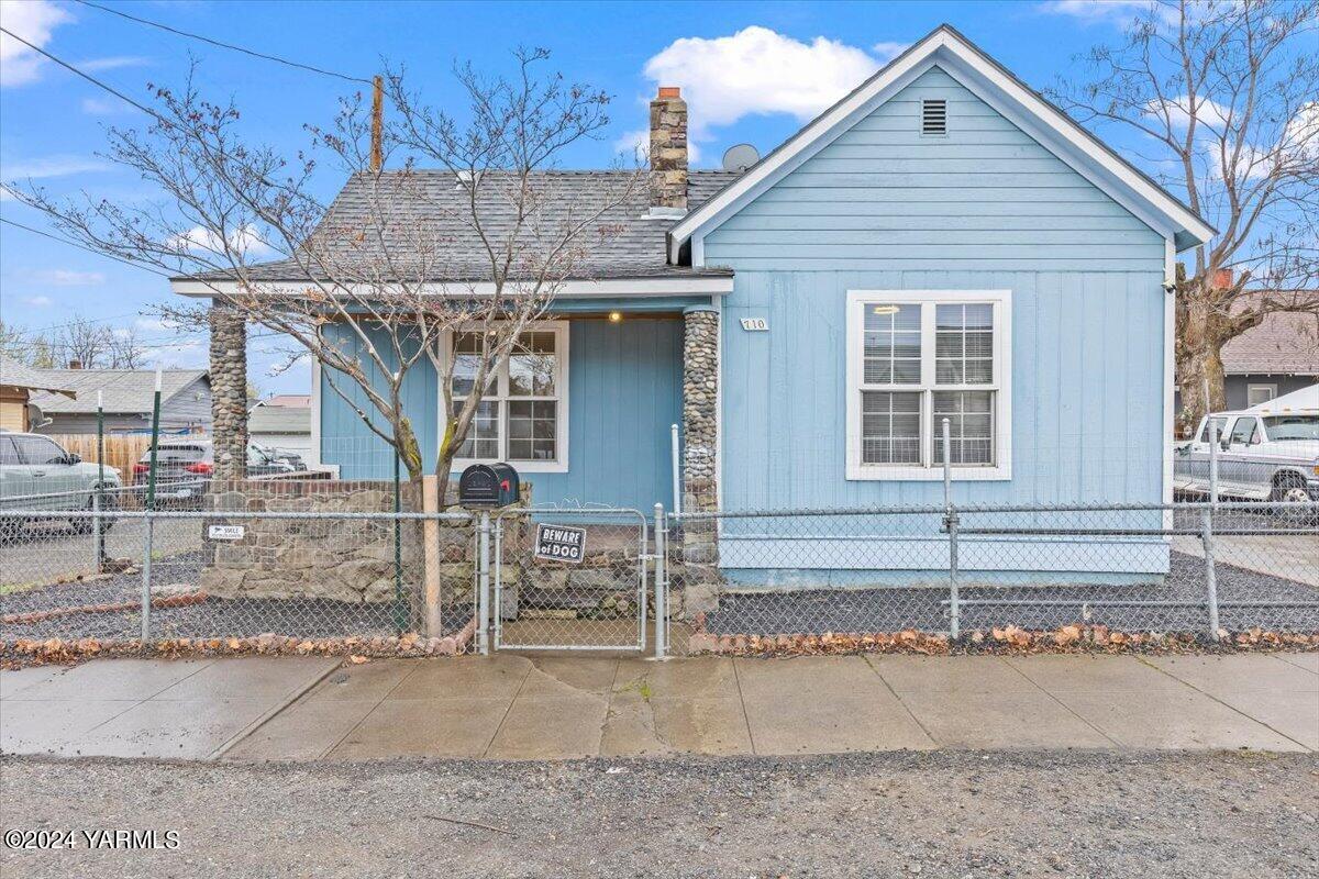 a view of a house with a patio and a yard
