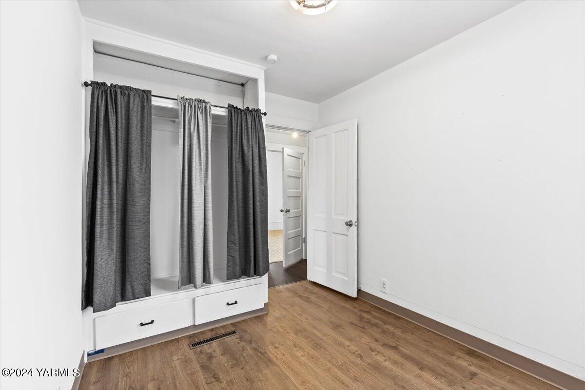 710 East Walnut Street Yakima, WA 98901 - Photo 8 of 15 a view of an empty room with wooden floor