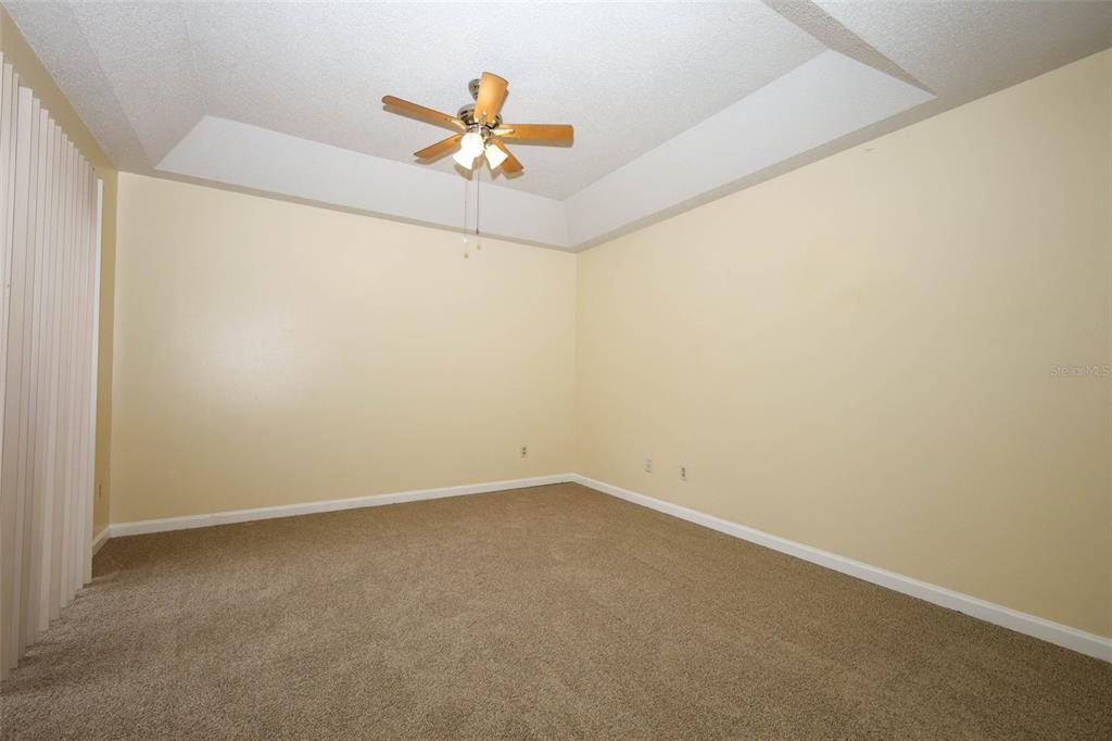 5405 Rutland Court Orlando, FL 32812 - Photo 11 of 33 an empty room with a ceiling fan and a window