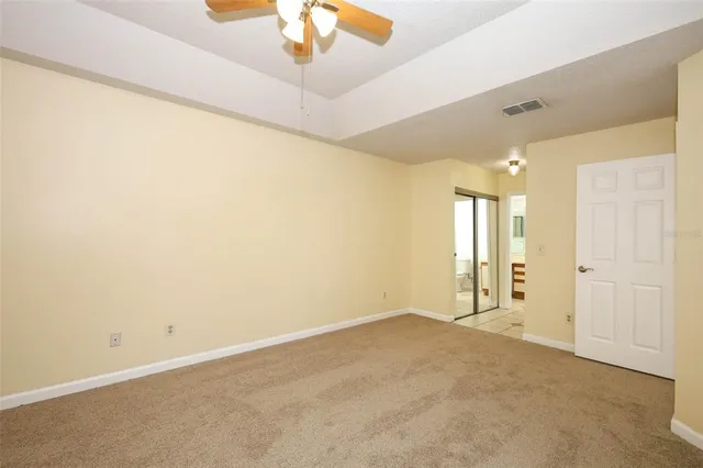 an empty room with a empty space and a ceiling fan