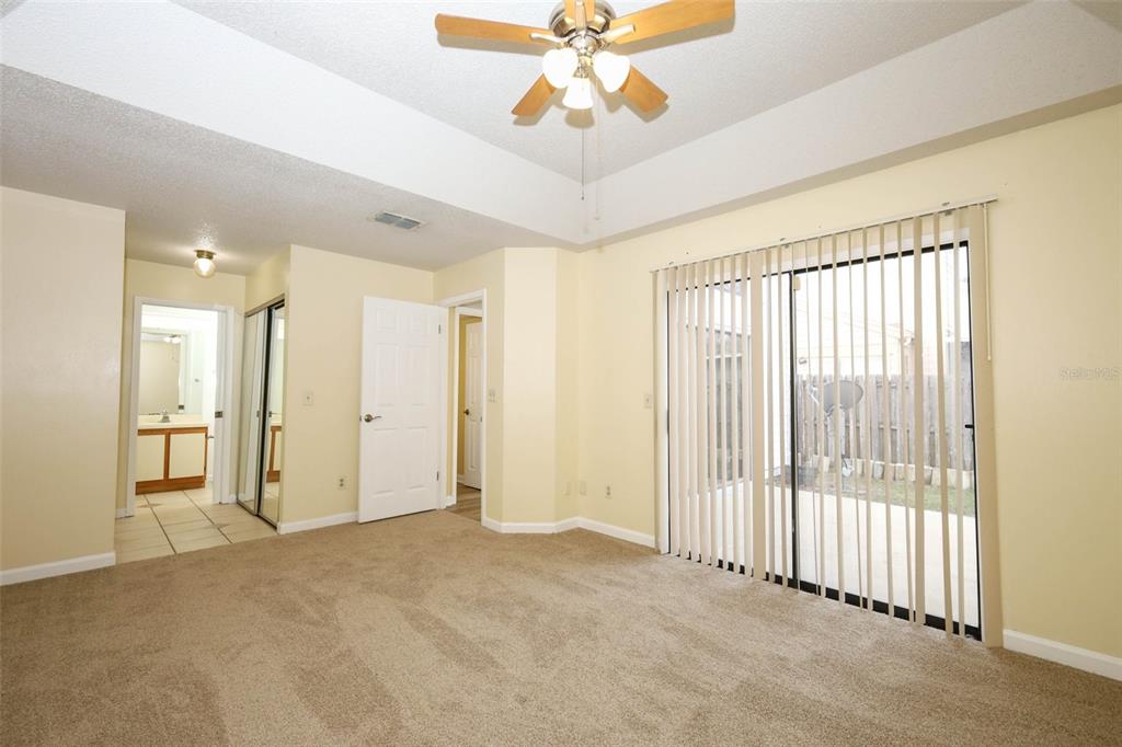 5405 Rutland Court Orlando, FL 32812 - Photo 13 of 33 a view of a livingroom with a chandelier fan and windows