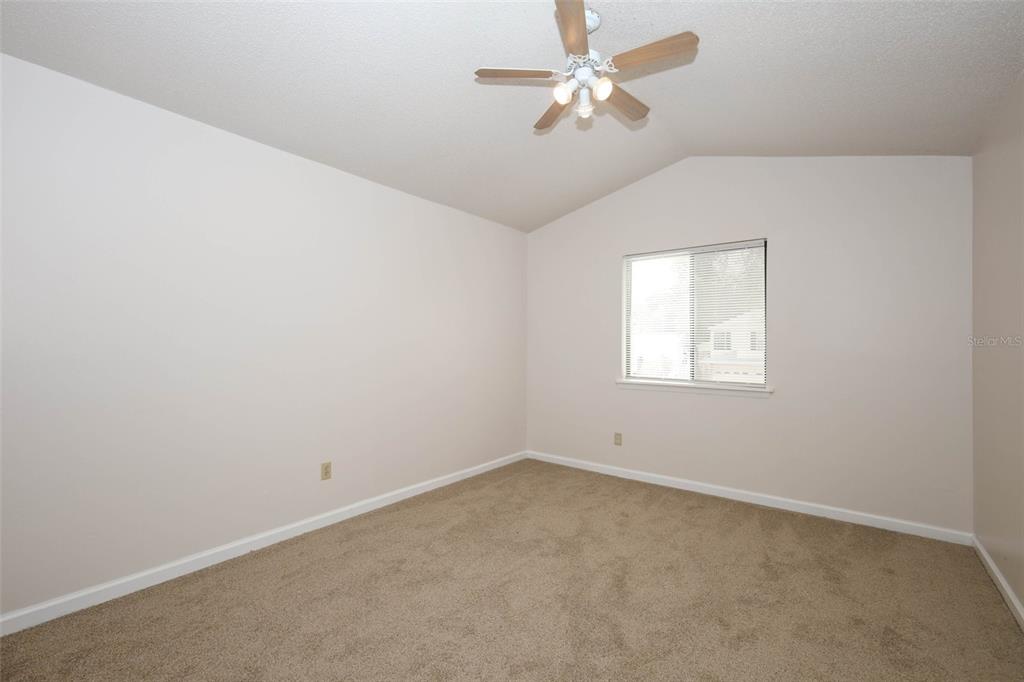5405 Rutland Court Orlando, FL 32812 - Photo 19 of 33 an empty room with a window and ceiling fan
