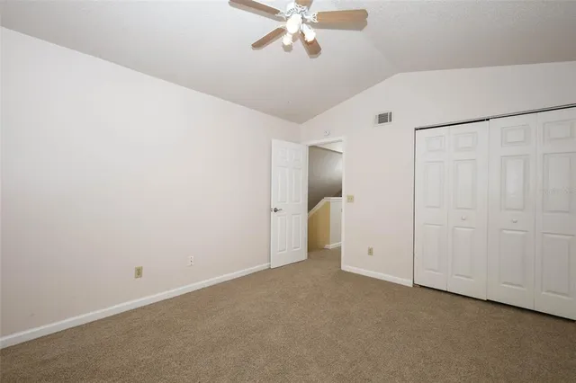 a view of a livingroom with a ceiling fan and window