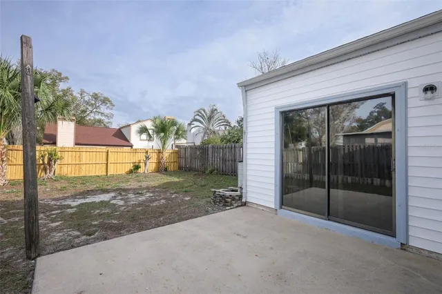 a view of a house with a yard and potted plants