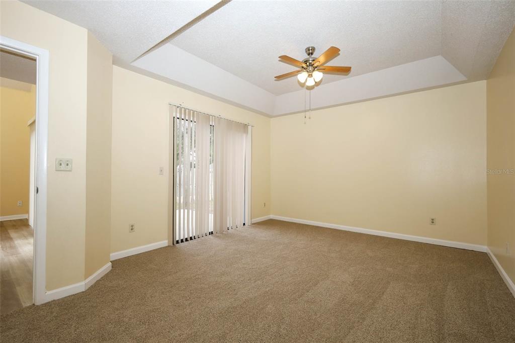 5405 Rutland Court Orlando, FL 32812 - Photo 10 of 33 an empty room with a ceiling fan and a window