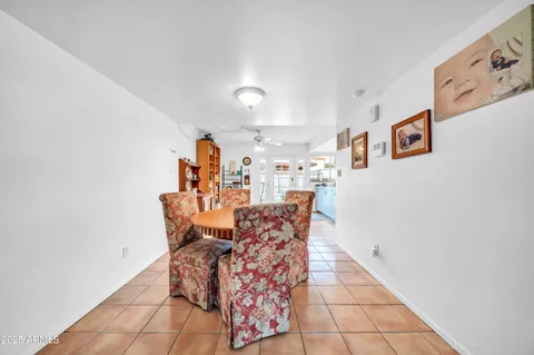a living room with furniture a flat screen tv and a window