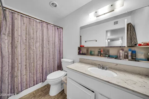 a living room with furniture a ceiling fan and a window