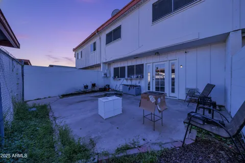 a view of a house with backyard and sitting area