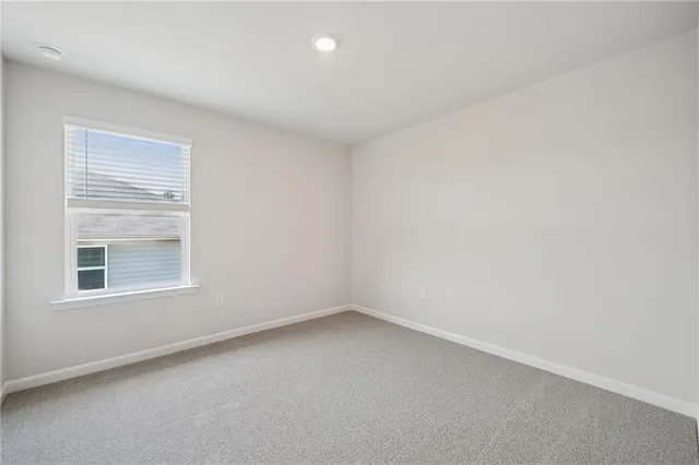 a view of an empty room and a window
