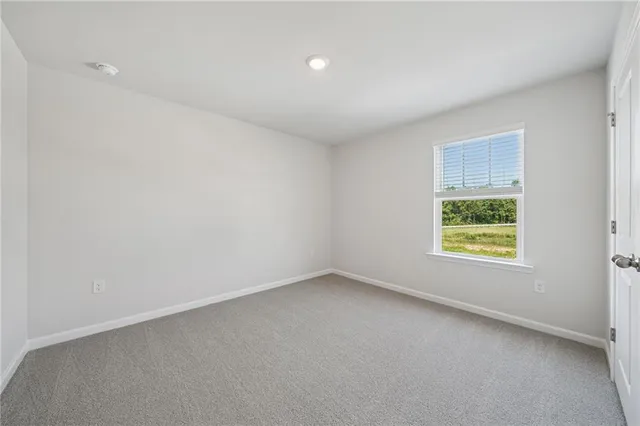 an empty room with a empty space and windows