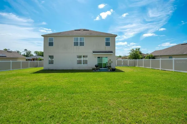 a kitchen with stainless steel appliances granite countertop a sink a stove a refrigerator and a refrigerator