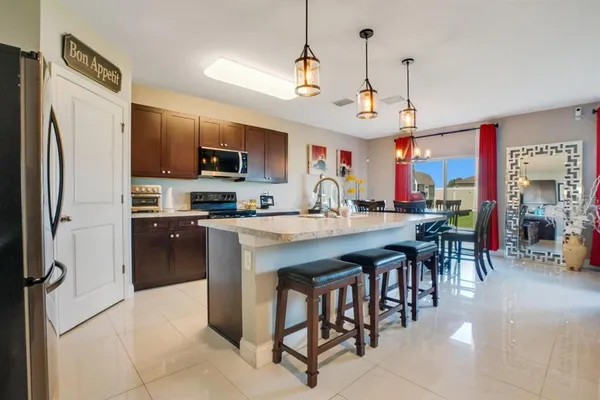a kitchen with stainless steel appliances a sink stove and refrigerator