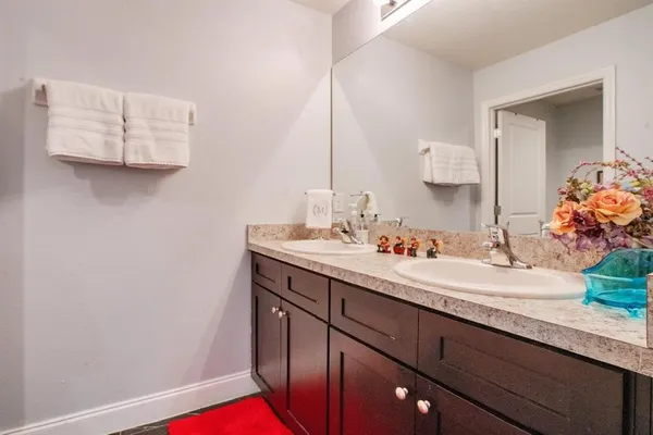 a bathroom with a granite countertop sink and a mirror