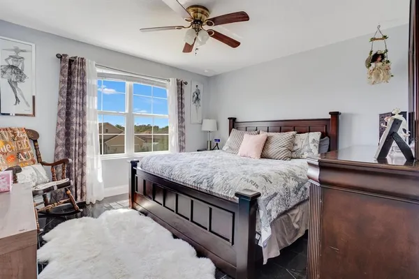 a bedroom with a large bed and a window