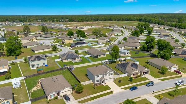 an aerial view of residential houses with outdoor space