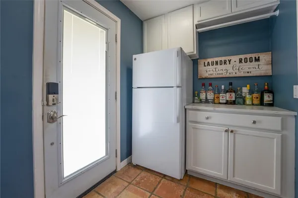a white refrigerator freezer sitting inside of a kitchen