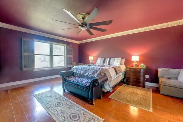 a spacious bedroom with a bed and a couch