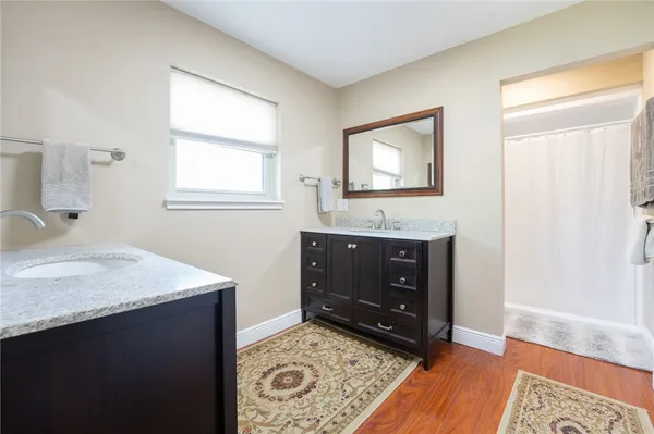 a bathroom with a sink vanity and a mirror