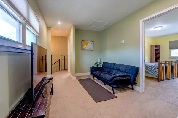 a living room with a couch and a dresser next to a window