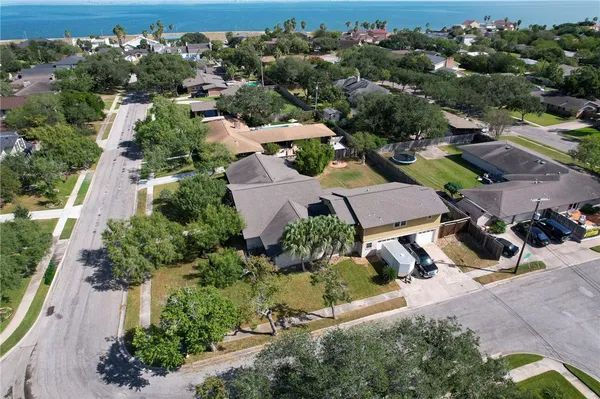 an aerial view of a houses with a yard