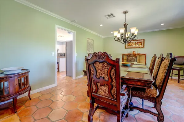 a view of a dining room with furniture and chandelier