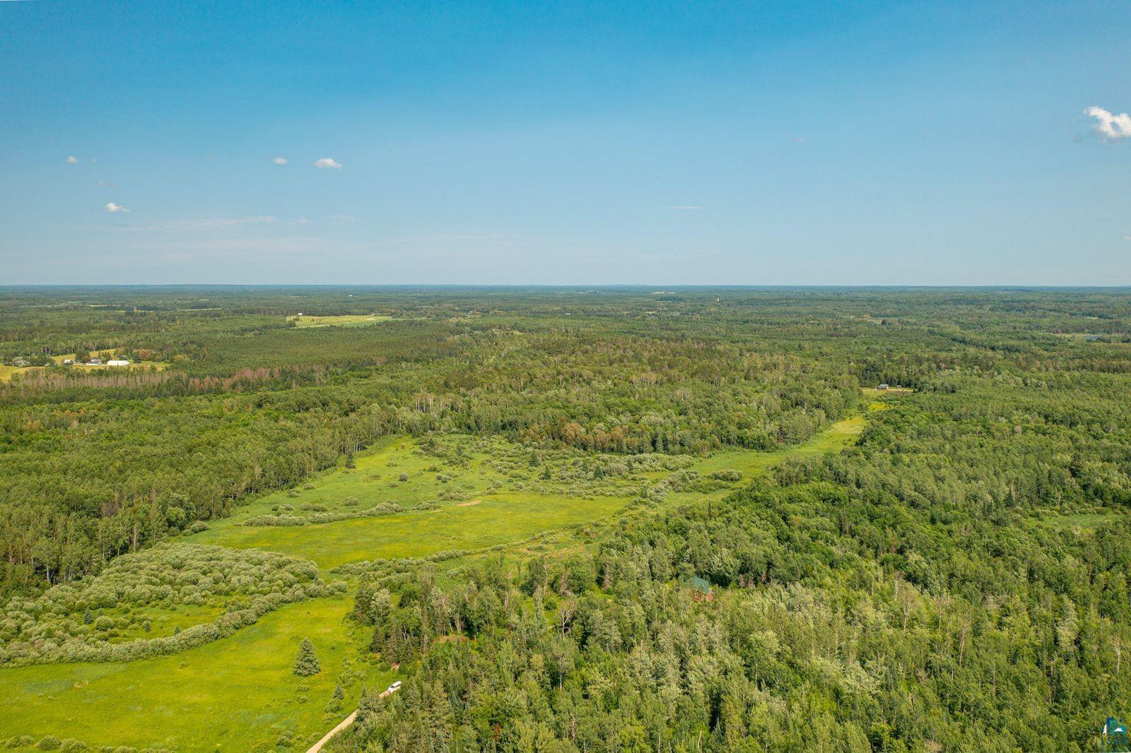 9734 Alango Road Angora, MN 55703 - Photo 38 of 41 Expansive land parcel featuring dense woodlands and open grassy areas
