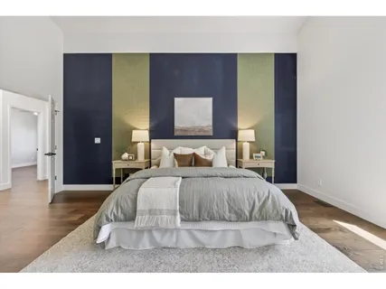 a bedroom with a bed and a night stand