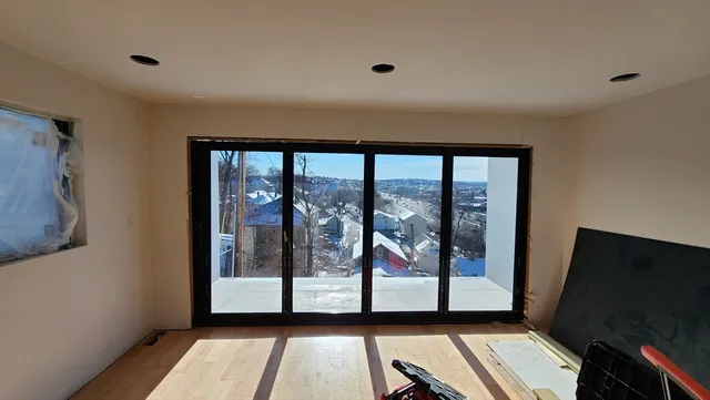 a view of a room with window and wooden floor
