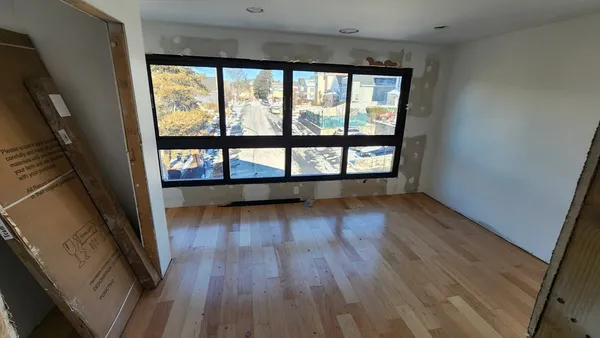 a view of a room with wooden floor
