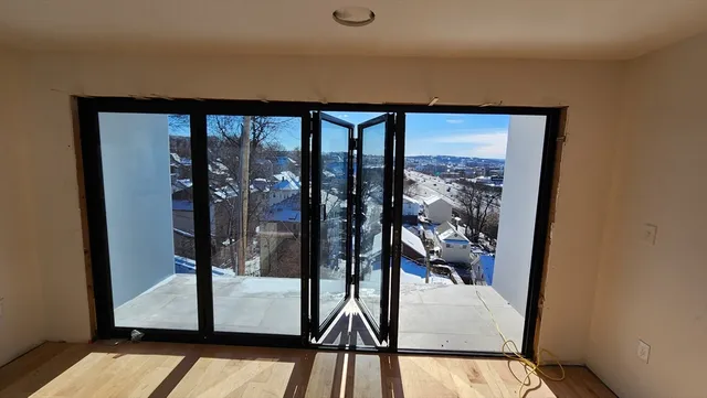 wooden floor in an empty room with a window