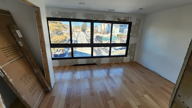 a view of a room with wooden floor
