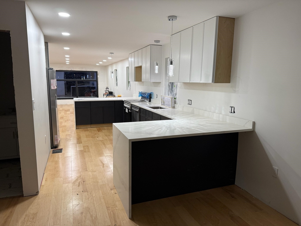 47 Laurel Street, Unit 47 Worcester, MA 01605 - Photo 23 of 23 a kitchen with stainless steel appliances sink a microwave and cabinets