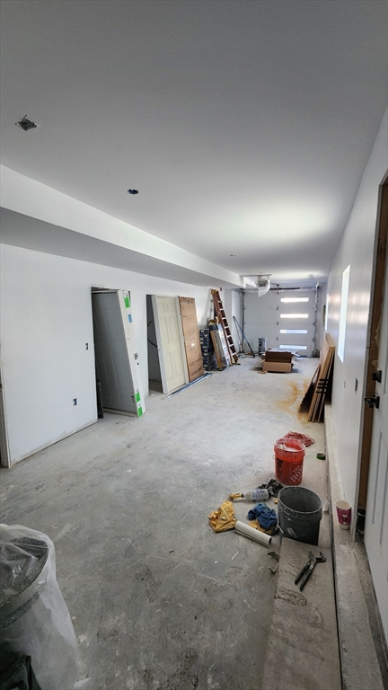 47 Laurel Street, Unit 47 Worcester, MA 01605 - Photo 3 of 23 a bedroom with a bed and gym equipment