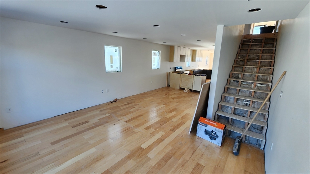 47 Laurel Street, Unit 47 Worcester, MA 01605 - Photo 5 of 23 wooden floor in an empty room with a fireplace