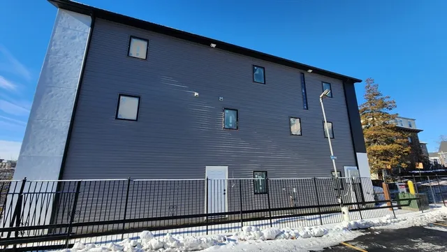 a view of a brick house with a street