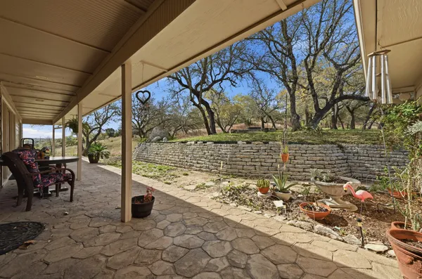 a living room with furniture a flat screen tv and kitchen view