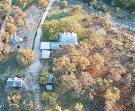 a kitchen with stainless steel appliances kitchen island granite countertop a refrigerator a stove a oven and white cabinets with wooden floor