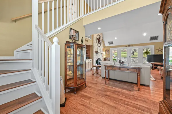 a dining room with furniture a window and wooden floor