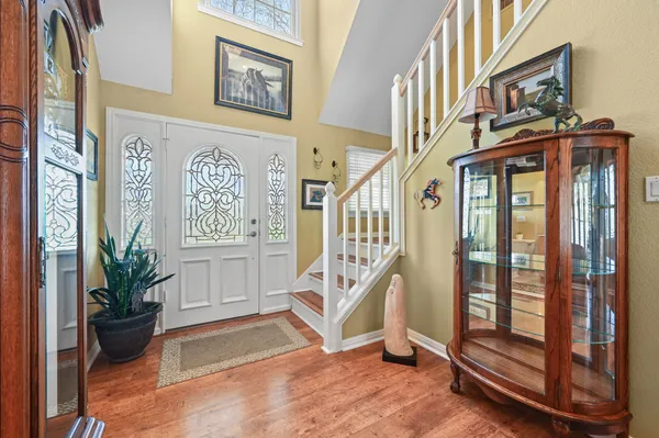 a kitchen with kitchen island granite countertop a sink cabinets and stainless steel appliances