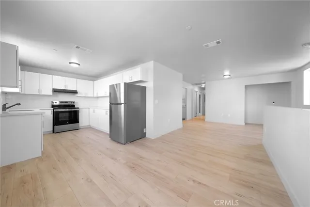 a kitchen with white cabinets and white appliances