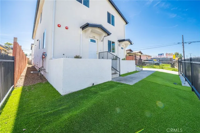 a view of a house with a yard and sitting area