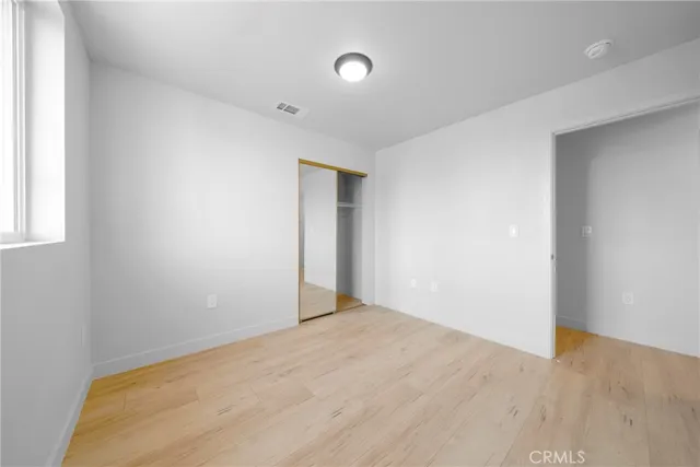 a view of a room with wooden floor and bathroom