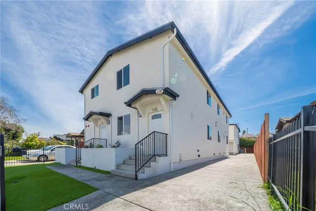 a view of a house with a backyard and garage