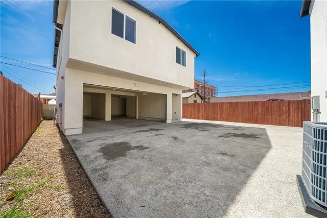 a view of a kitchen with a sink and refrigerator